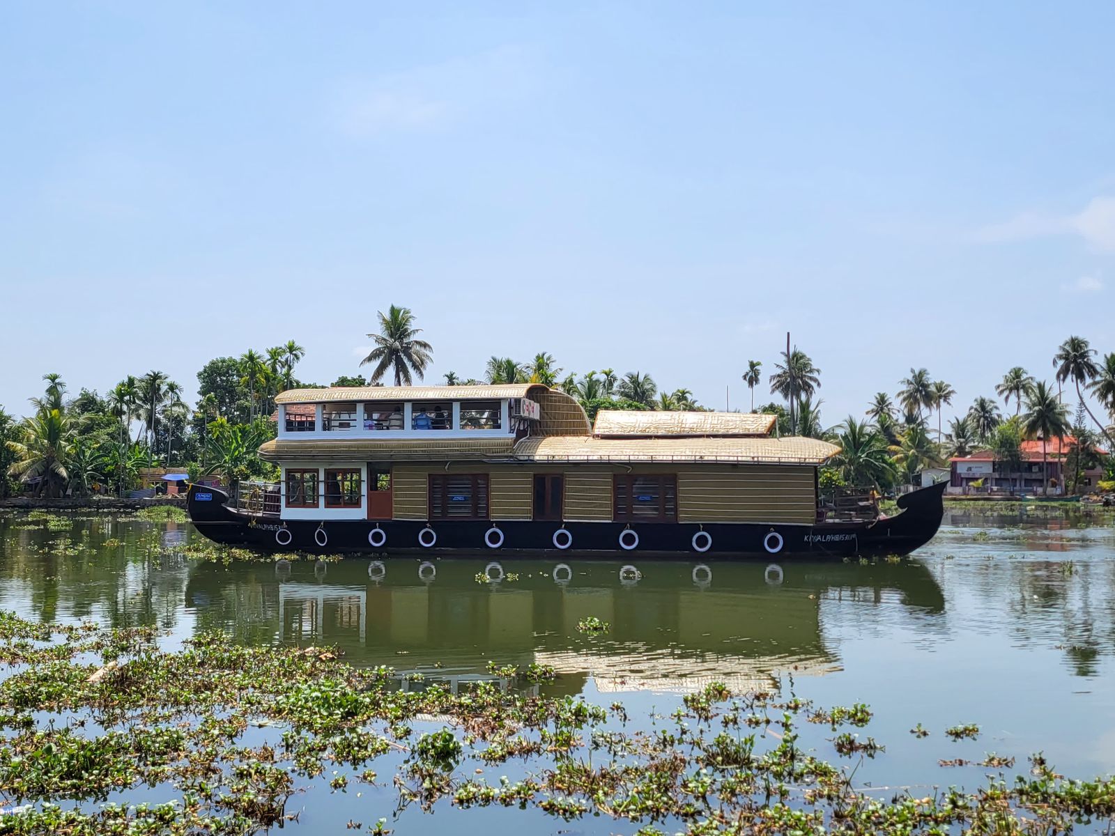 Angel Houseboats vessel reflected on the backwater